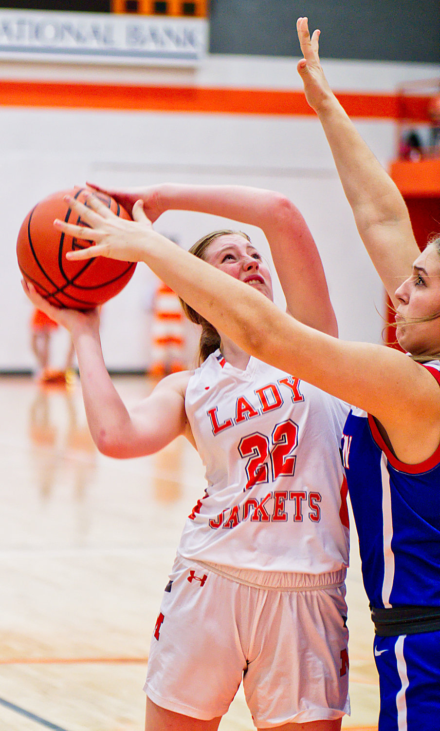 Macy Fischer puts up a shot closely contested by Annabelle Popek. [see more shots, buy basketball photos]